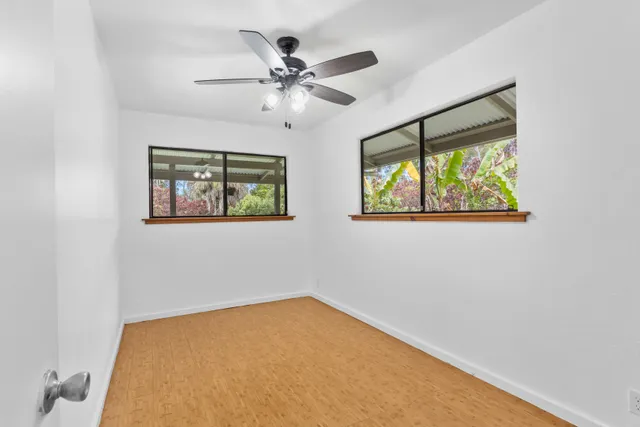 a view of room with window and ceiling fan
