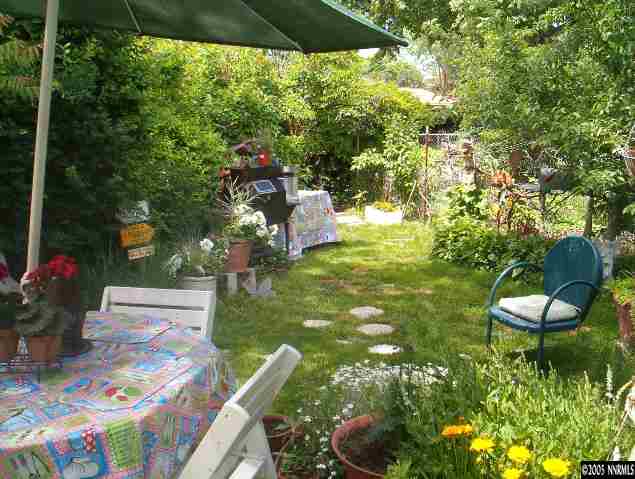 765 Bates Avenue Reno, NV 89502 - Photo 4 of 9 a backyard of a house with table and chairs under an umbrella