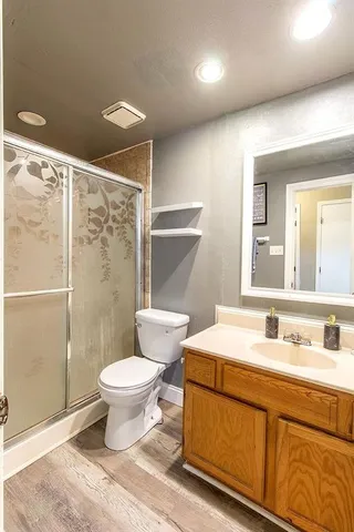 a bathroom with a sink toilet and shower