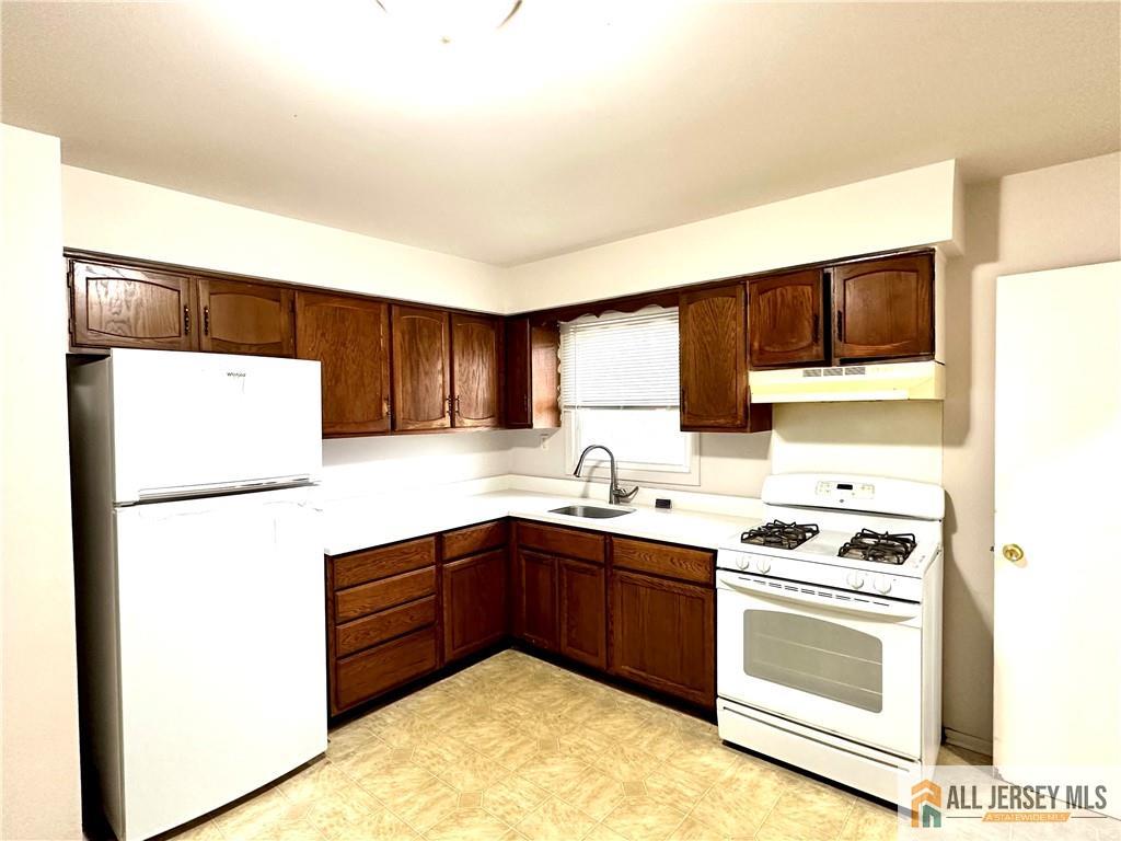 a kitchen with a sink a stove and refrigerator