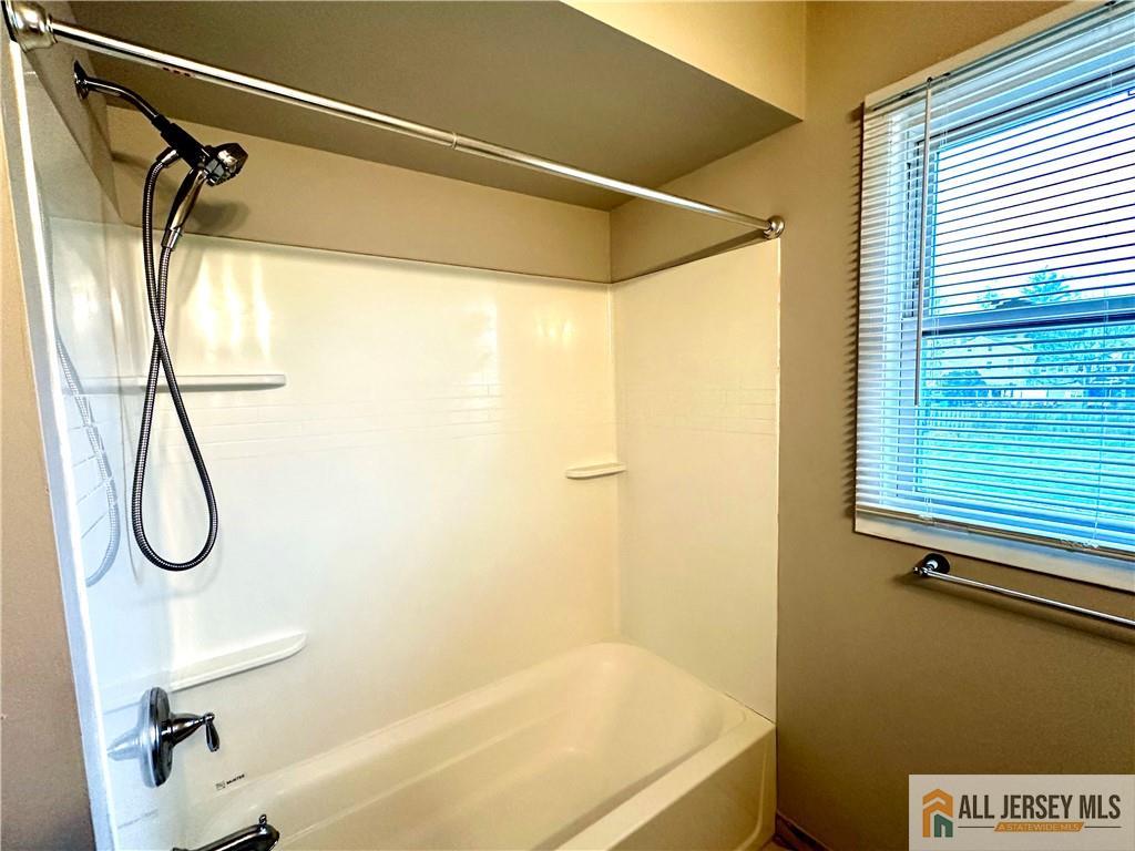909 Hermann Road North Brunswick, NJ 08902 - Photo 8 of 11 a bathroom with a bath tub with a shower