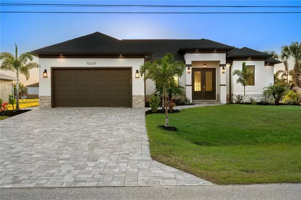 a front view of a house with a yard and garage