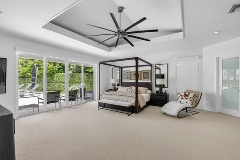 a bedroom with furniture and a large window