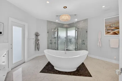a spacious bathroom with a bathtub and shower