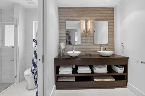 a bathroom with a sink a toilet and a mirror