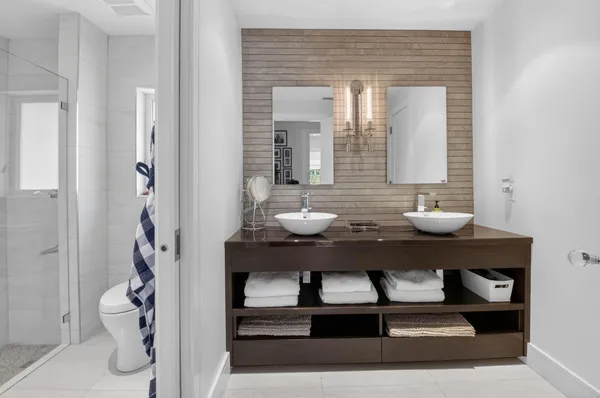 a bathroom with a sink a toilet and a mirror