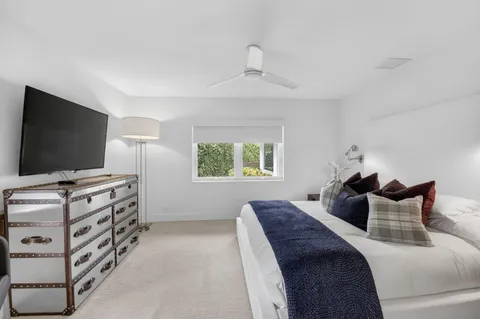 a bedroom with furniture and a flat screen tv