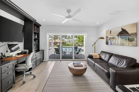a living room with furniture a rug and a large window