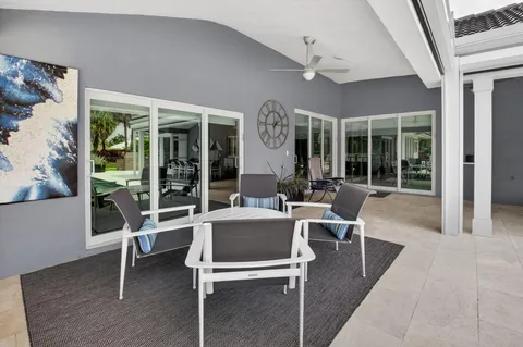 a dining room with wooden floor and furniture