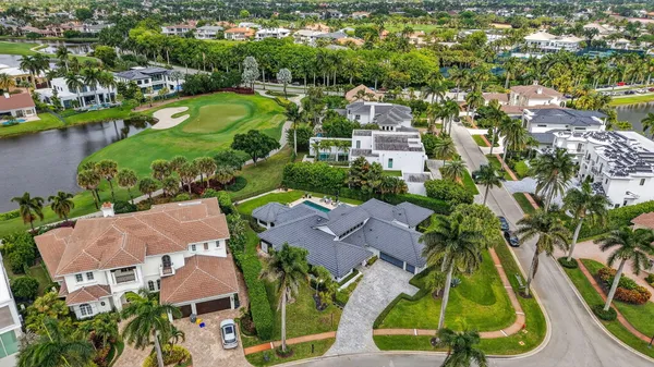 an aerial view of residential houses with outdoor space and river