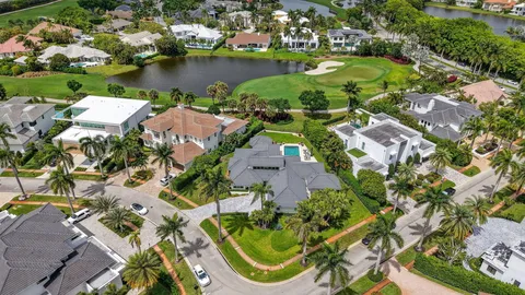 an aerial view of a house with outdoor space and lake view