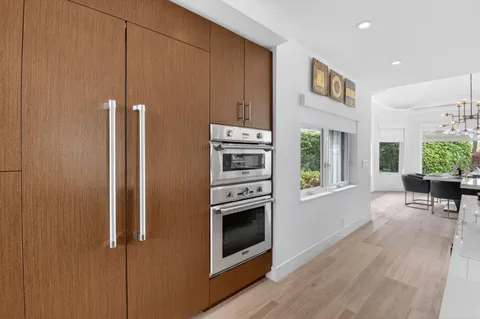 a kitchen with a refrigerator and a table
