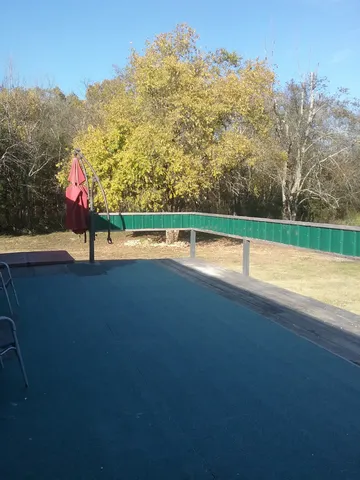 a view of swimming pool with an outdoor seating