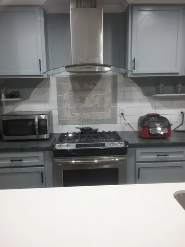 a kitchen with a stove and cabinets