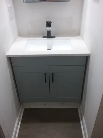 a bathroom with a sink and vanity