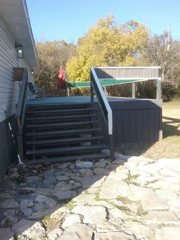 a view of balcony with wooden floor and fence