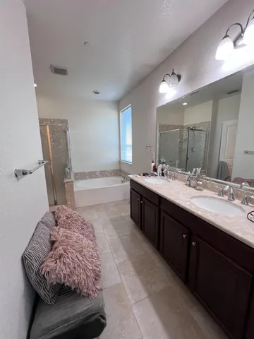 a bathroom with a double vanity sink and a mirror