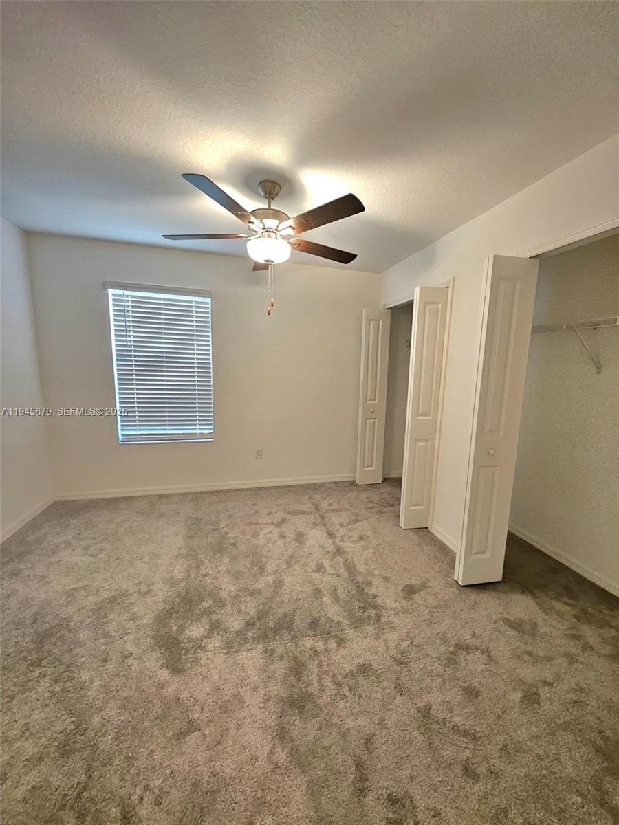 6346 Back Forty Loop, Unit 6346 Zephyrhills, FL 33541 - Photo 13 of 35 an empty room with a ceiling fan and window
