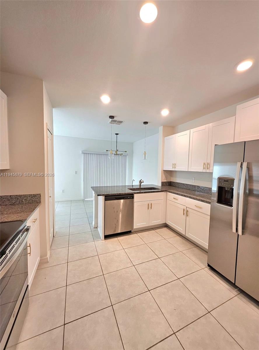 6346 Back Forty Loop, Unit 6346 Zephyrhills, FL 33541 - Photo 22 of 35 a large kitchen with a stove a sink and a refrigerator