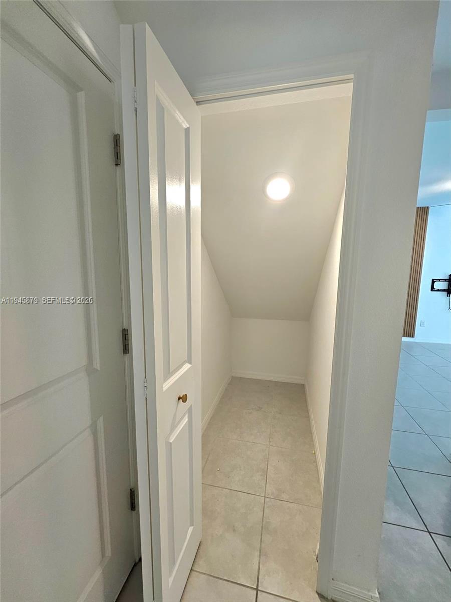 6346 Back Forty Loop, Unit 6346 Zephyrhills, FL 33541 - Photo 26 of 35 an empty room with mirror and a bathroom