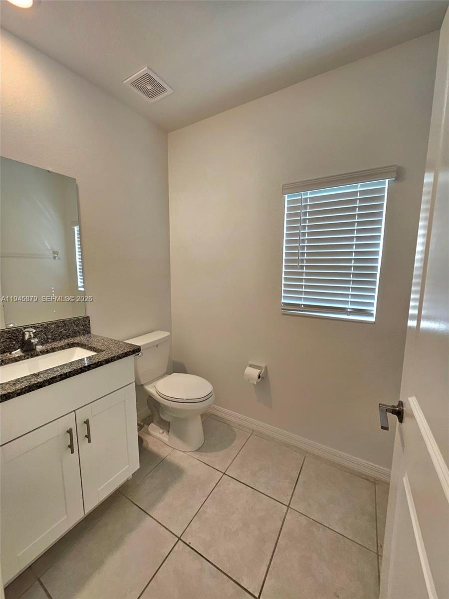 6346 Back Forty Loop, Unit 6346 Zephyrhills, FL 33541 - Photo 27 of 35 a bathroom with a toilet sink and mirror