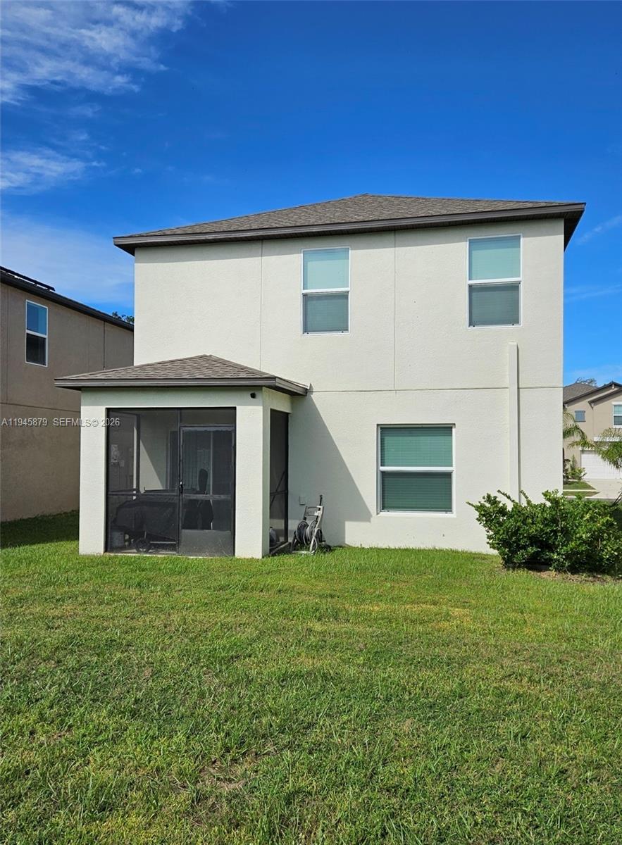 6346 Back Forty Loop, Unit 6346 Zephyrhills, FL 33541 - Photo 30 of 35 a view of a house with a yard