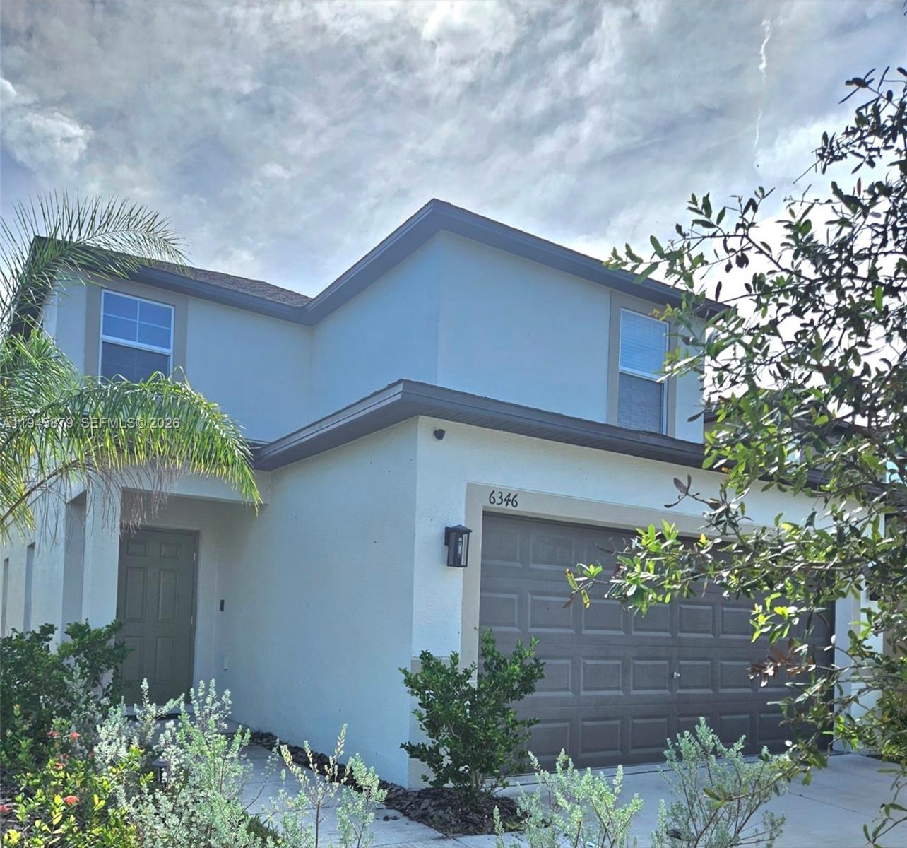 6346 Back Forty Loop, Unit 6346 Zephyrhills, FL 33541 - Photo 3 of 35 a house with a tree in front of it