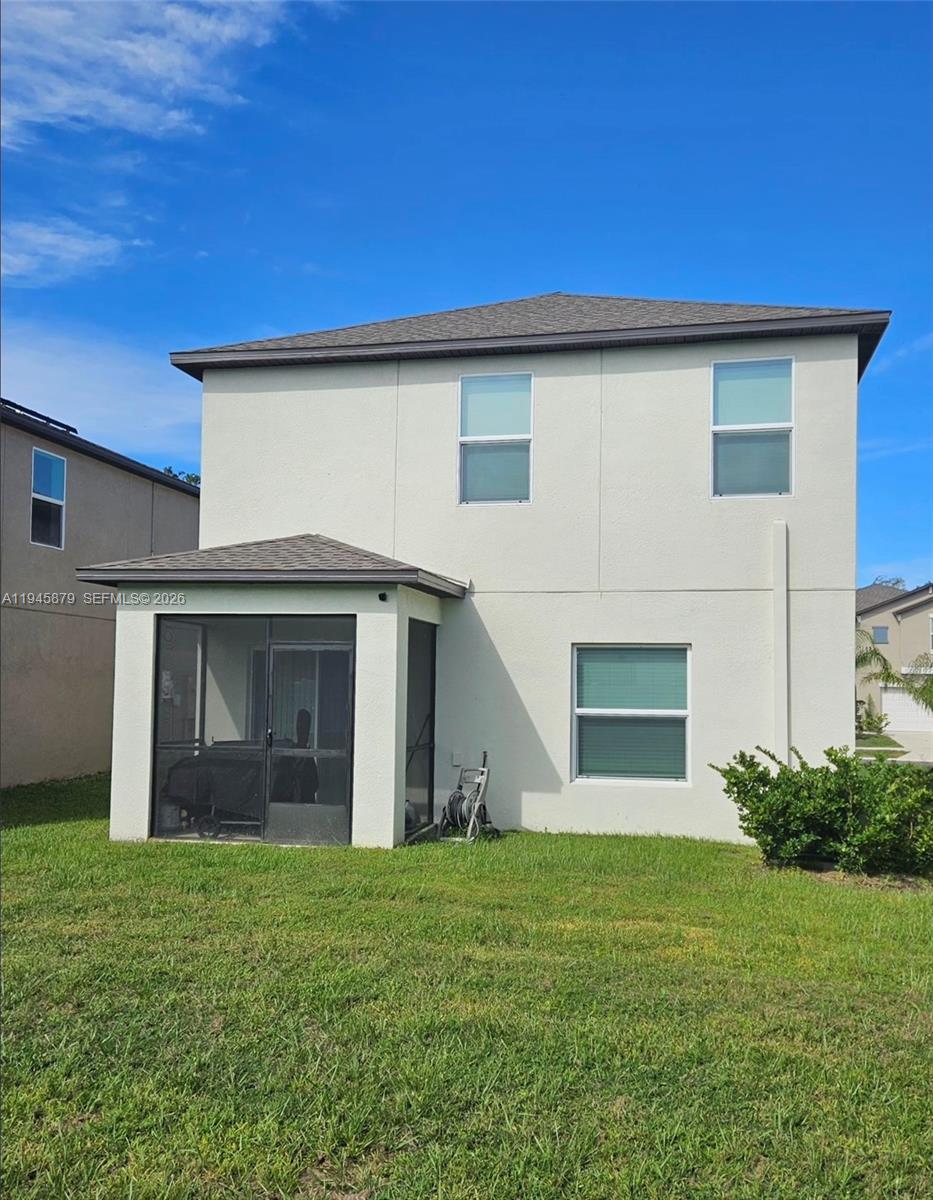 6346 Back Forty Loop, Unit 6346 Zephyrhills, FL 33541 - Photo 31 of 35 a view of a house with a garden