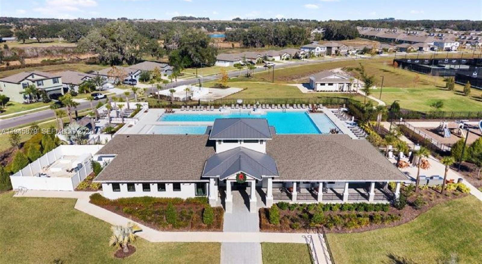 6346 Back Forty Loop, Unit 6346 Zephyrhills, FL 33541 - Photo 35 of 35 an aerial view of residential houses and lake