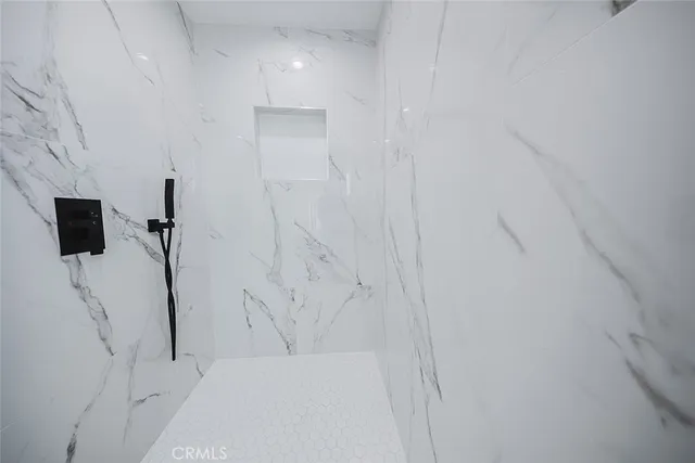 a large kitchen with stainless steel appliances granite countertop a stove a sink and a refrigerator