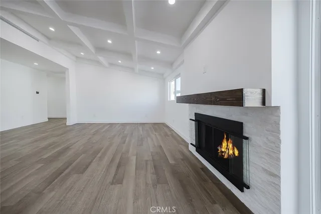 a large kitchen with stainless steel appliances kitchen island granite countertop a stove a sink dishwasher and a microwave