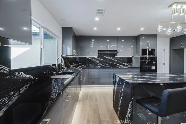 a bathroom with a sink vanity and shower