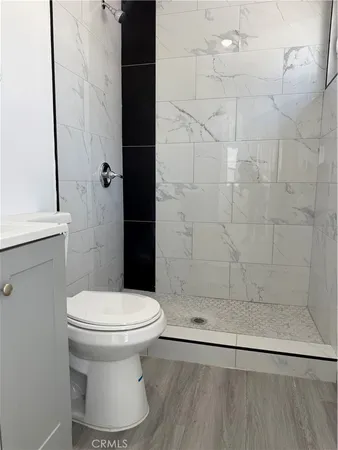 a bathroom with a toilet and a shower