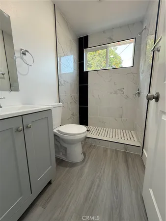 a bathroom with a sink a toilet and a window