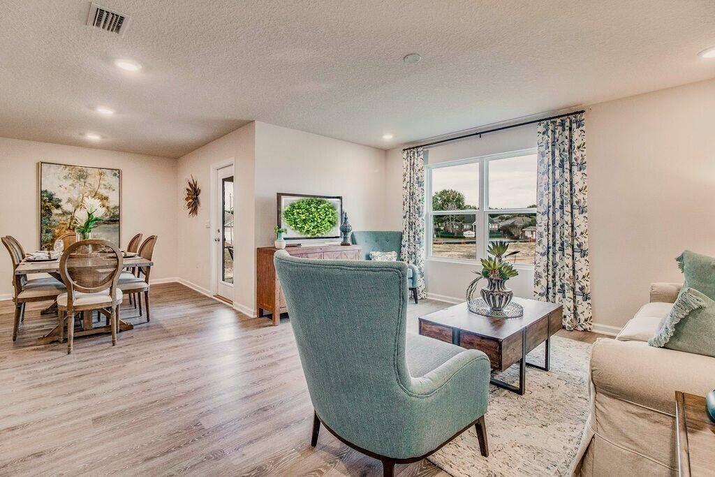 4742 Airmen Drive Crestview, FL 32539 - Photo 16 of 42 a living room with furniture and a wooden floor
