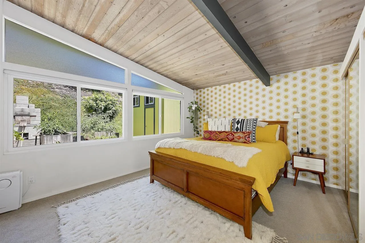 5635 Dartford Way San Diego, CA 92120 - Photo 11 of 26 a bed sitting in a bedroom next to a window