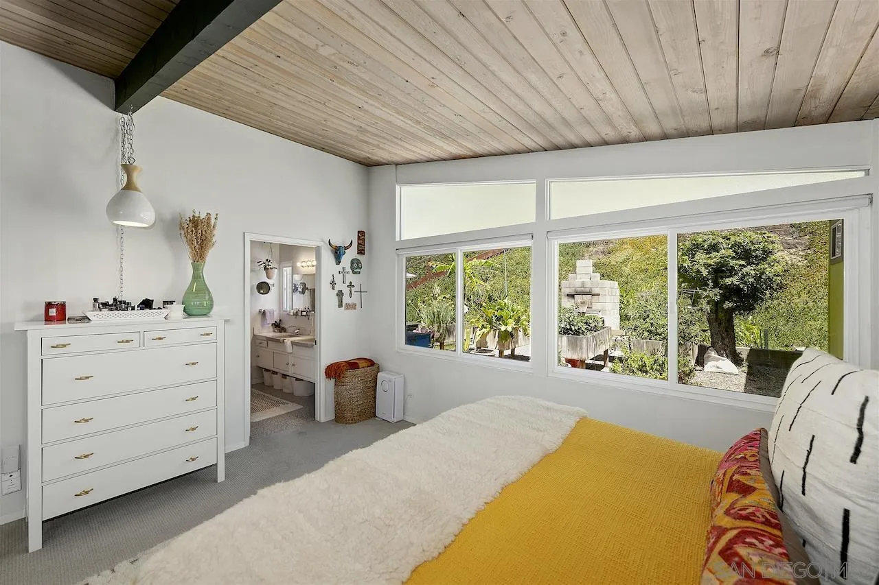 5635 Dartford Way San Diego, CA 92120 - Photo 12 of 26 a bed room with a bed and a large window