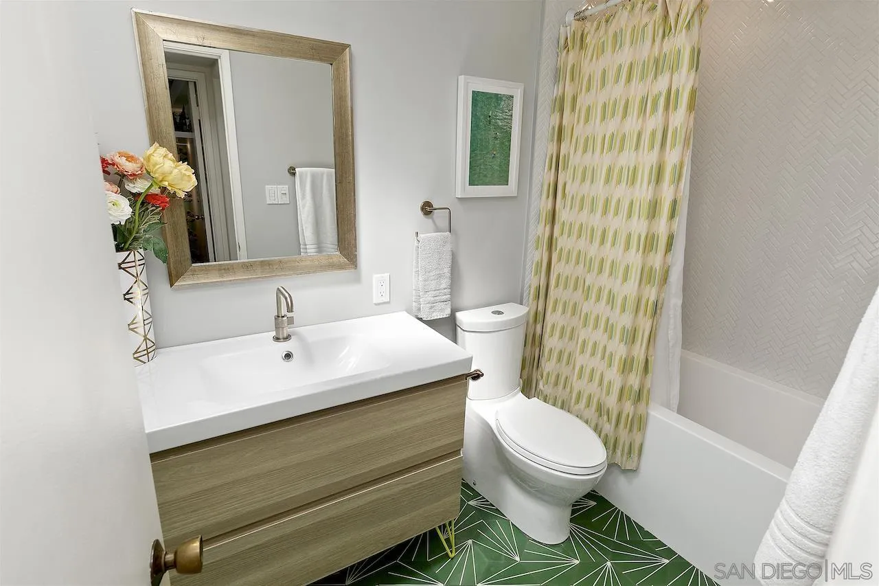 5635 Dartford Way San Diego, CA 92120 - Photo 18 of 26 a bathroom with a sink a toilet and a mirror