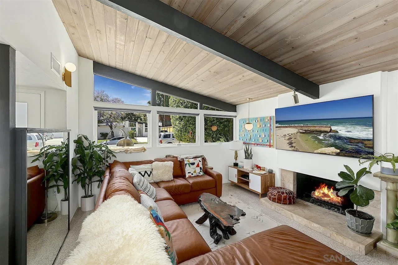 5635 Dartford Way San Diego, CA 92120 - Photo 3 of 26 a living room with furniture a fireplace a potted plant and a large window