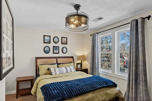 a bedroom with a bed and a window