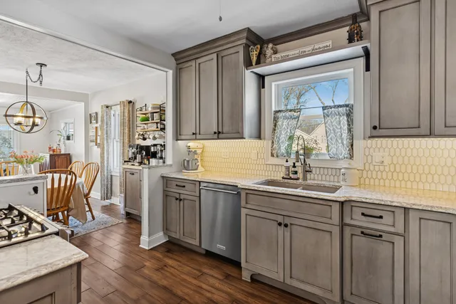 a kitchen with a sink cabinets and window