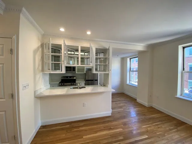a view of kitchen with wooden floor and window