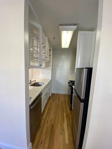 a view of a kitchen from the hallway