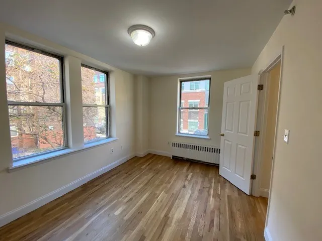 wooden floor in an empty room with a window