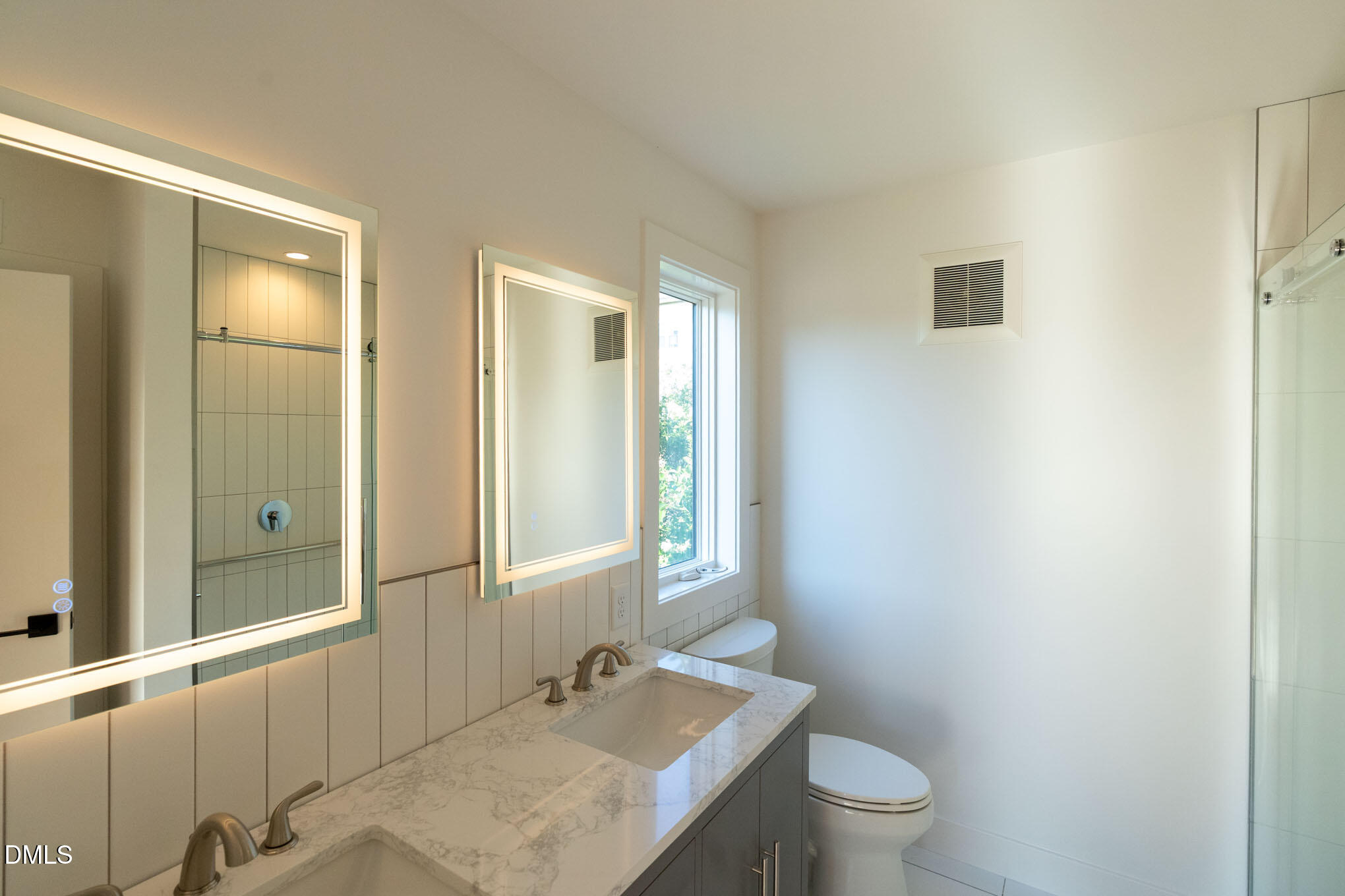 400 East Martin Street, Unit A Raleigh, NC 27601 - Photo 14 of 29 a bathroom with a granite countertop sink toilet and mirror