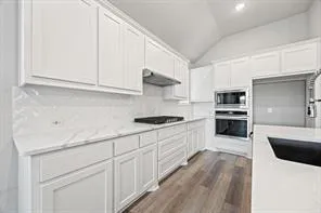 an empty room with windows and fireplace