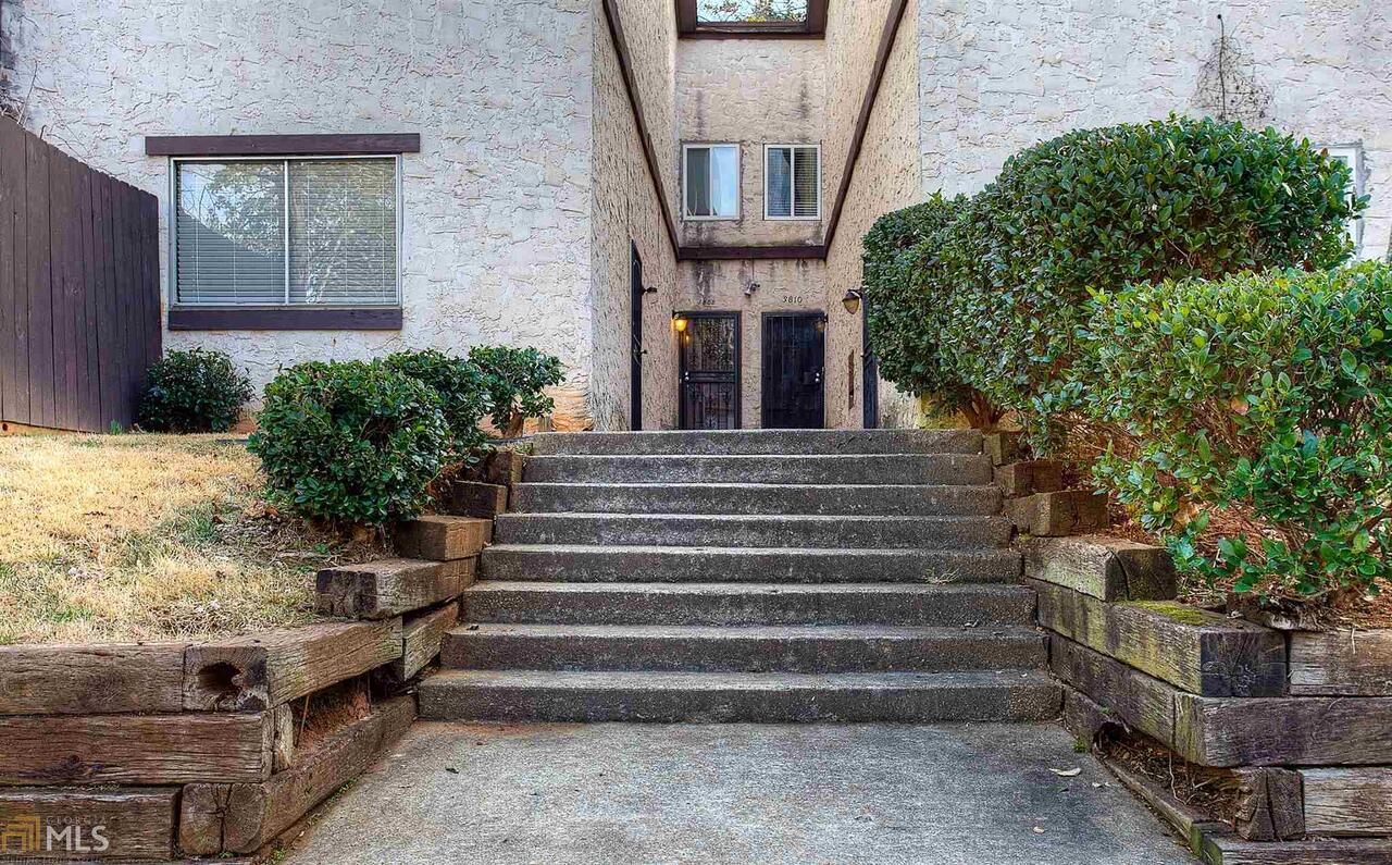 a front view of a house with potted plants