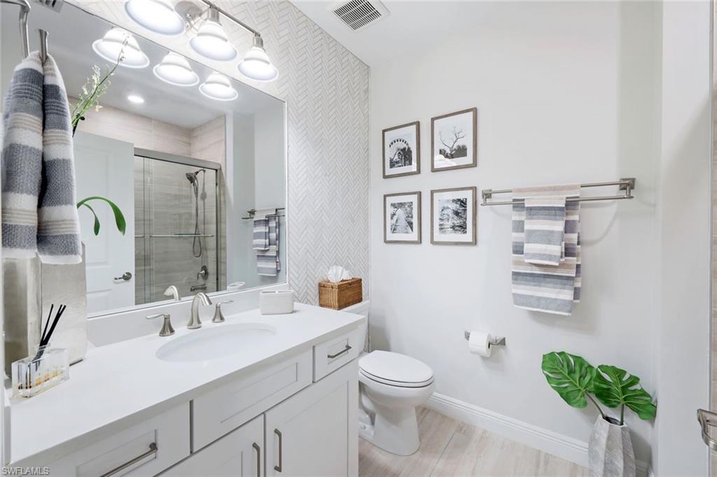 16348 Viansa Way, Unit 101 Naples, FL 34110 - Photo 16 of 34 Full Guest Bathroom #2 shower glass sliding door