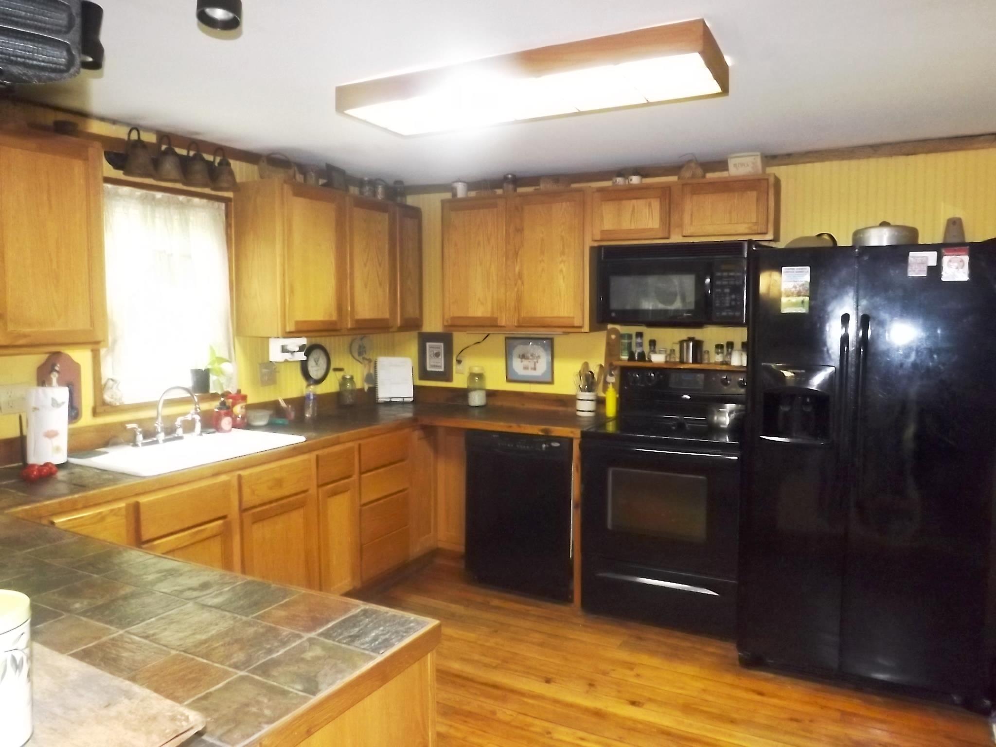 540 Parker Road Manchester, TN 37355 - Photo 17 of 30 a kitchen with stainless steel appliances granite countertop a stove a sink and a microwave