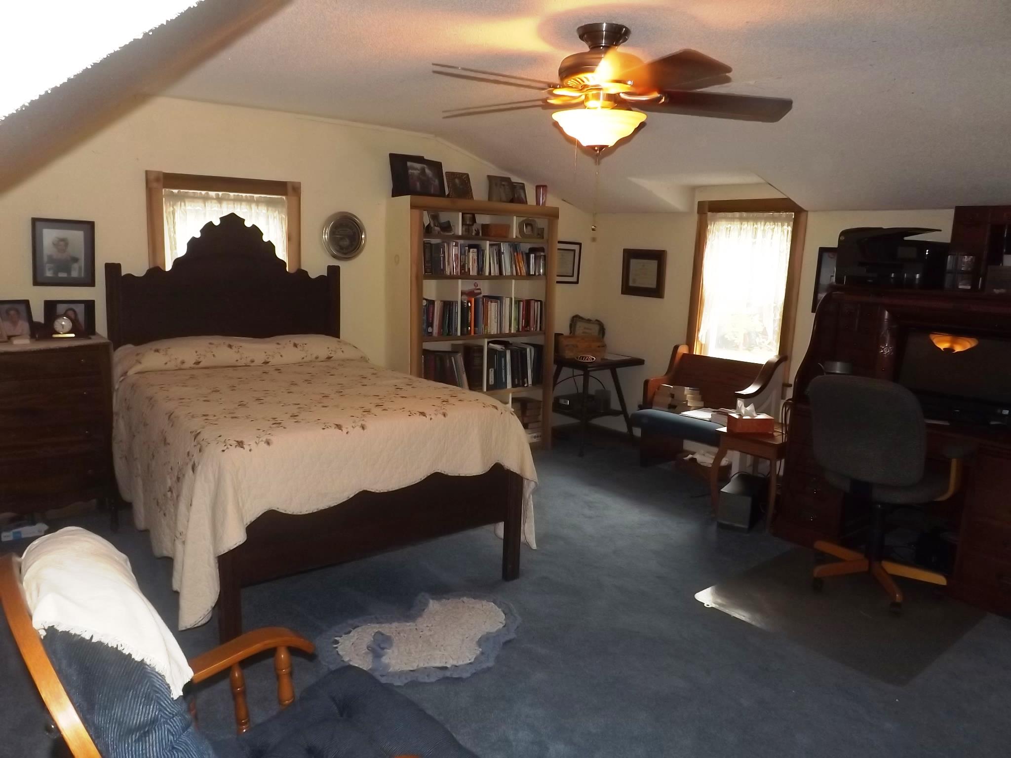 540 Parker Road Manchester, TN 37355 - Photo 24 of 30 a bedroom with a bed gym equipment and a chandelier